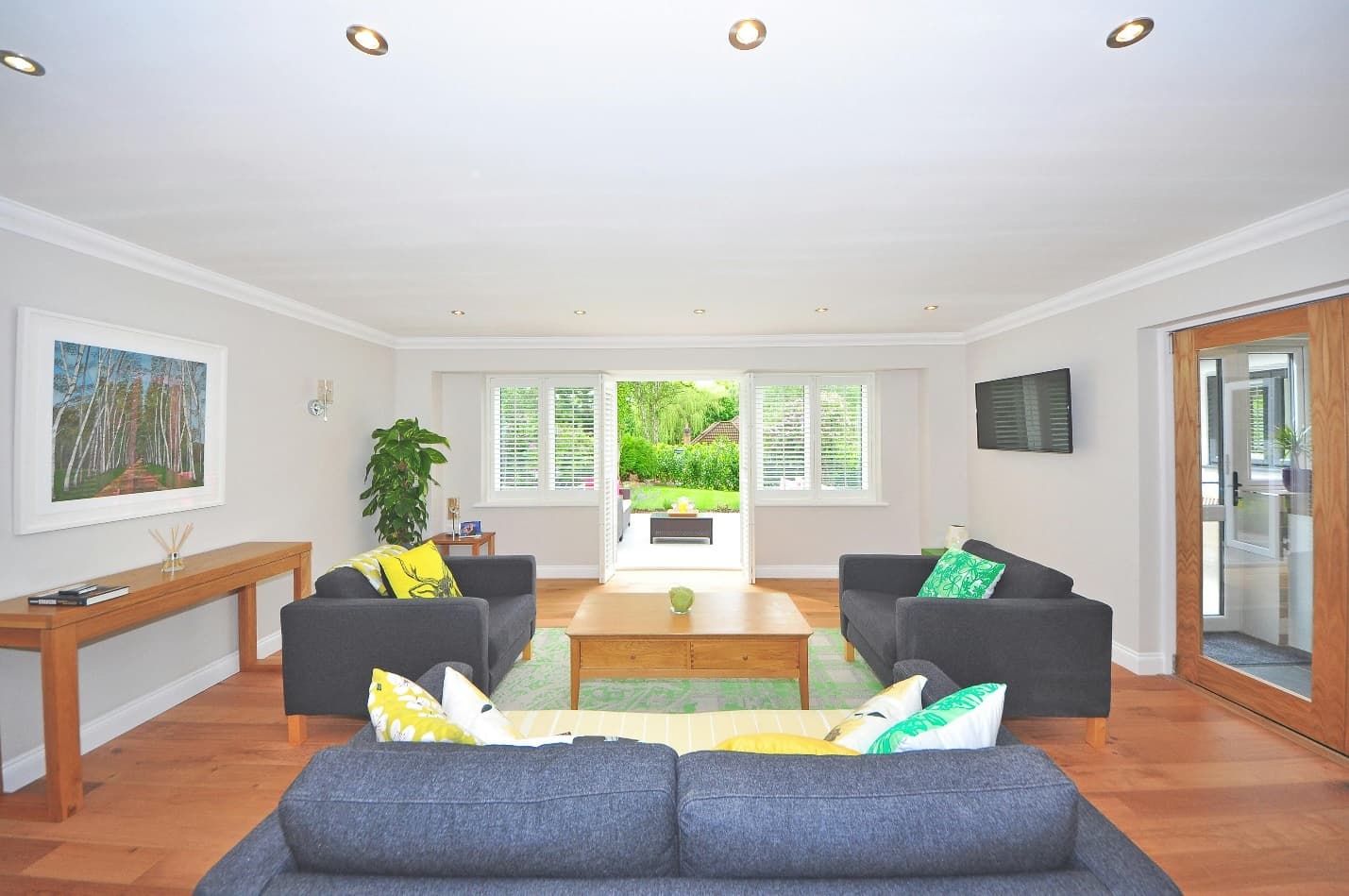 living room with dark gray sofa sets and wooden center table