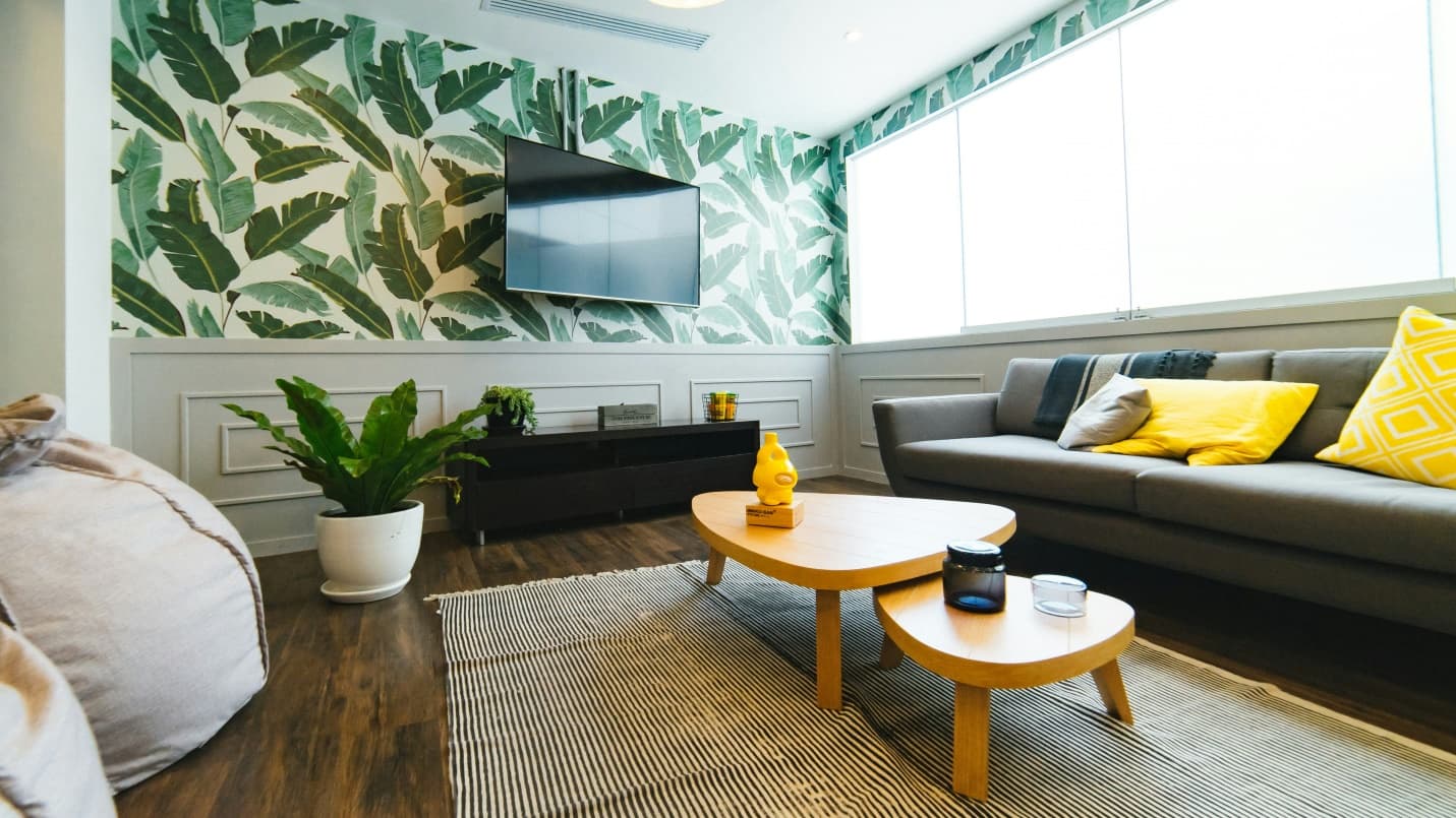 flat screen TV in a living room with sofa set and coffee table