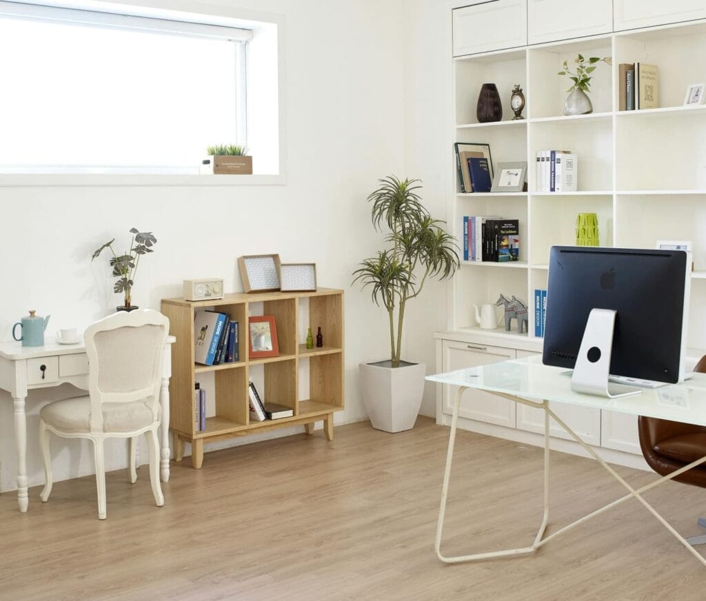 a room with book shelves and computer