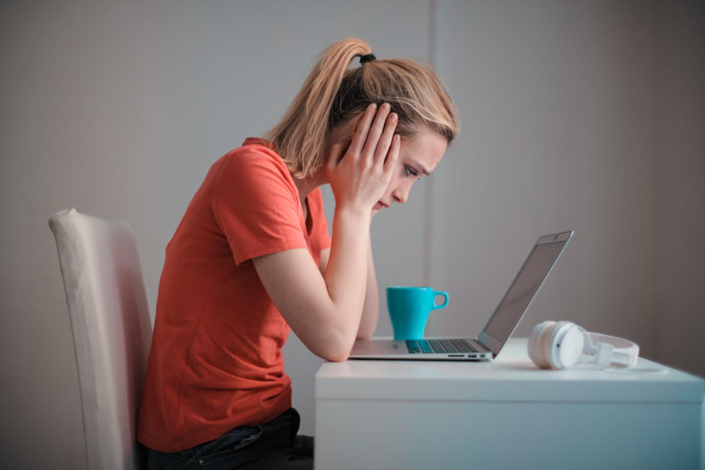 A woman sitting thinking about making a decision