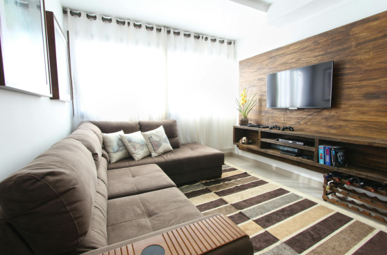 brown rug near couch and TV