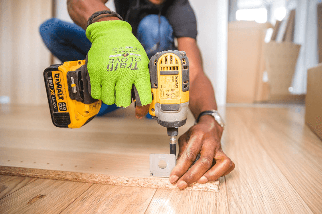 A person working on installing floor panels