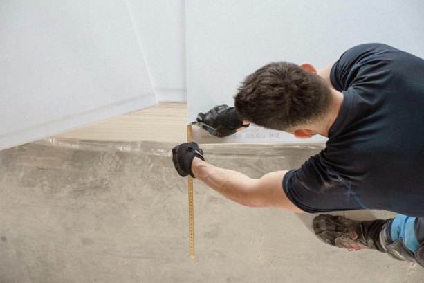 Skilled installer working with precision tools to achieve a flawless flooring finish.