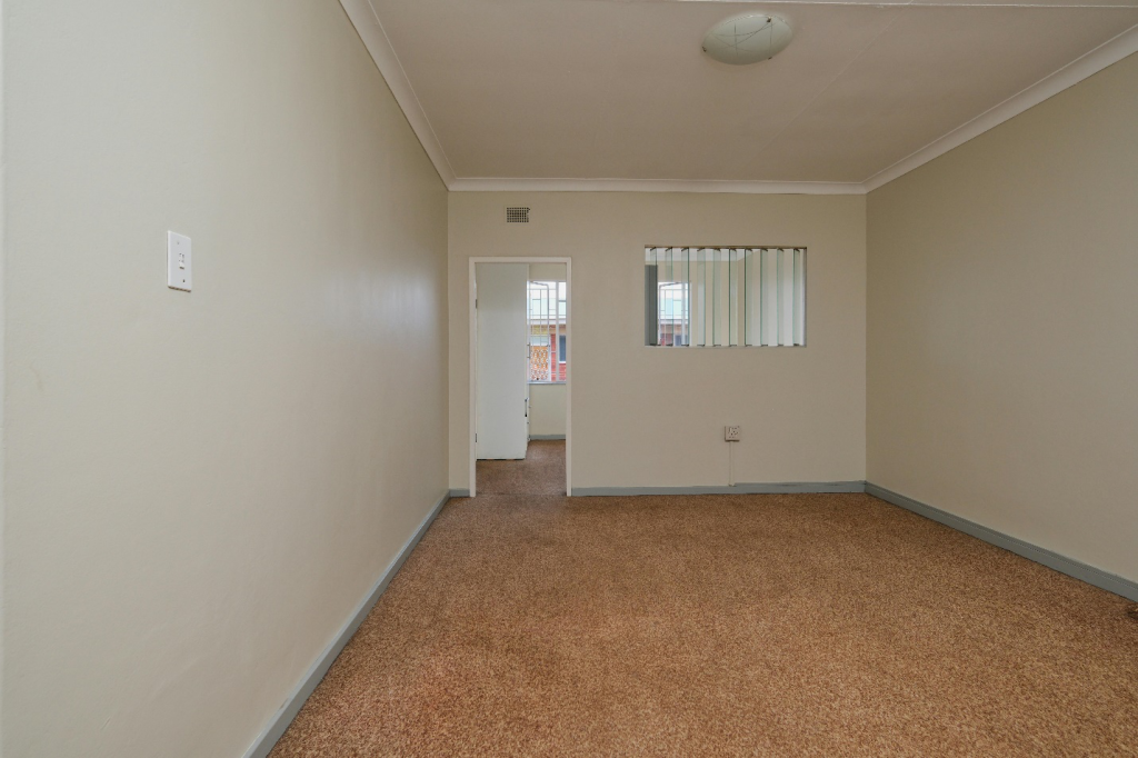an empty room with carpet flooring