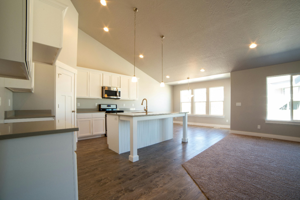 White theme kitchen with dark wood flooring
